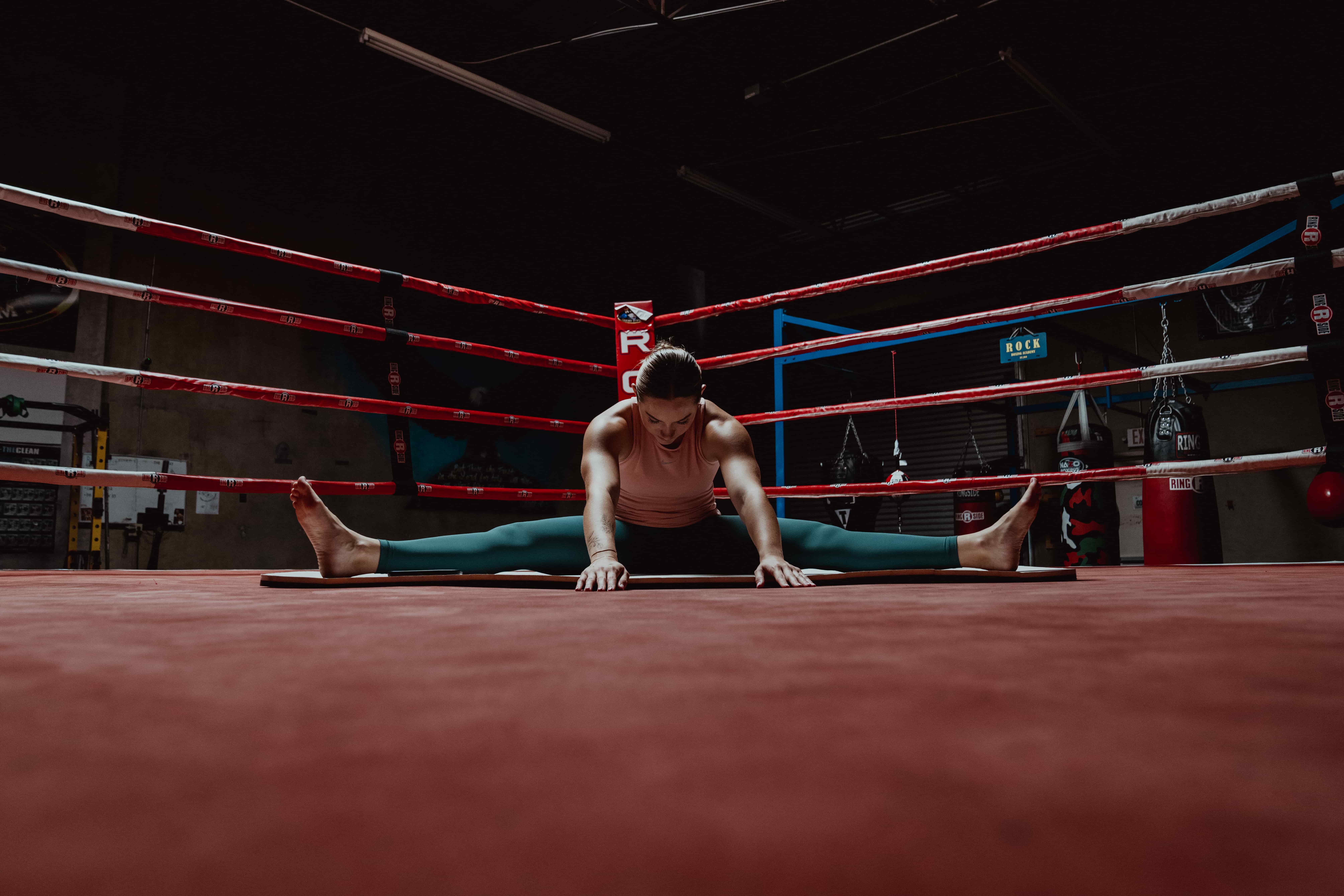 Woman Stretching in Boxing Ring - Stretch Before Or After Workout
