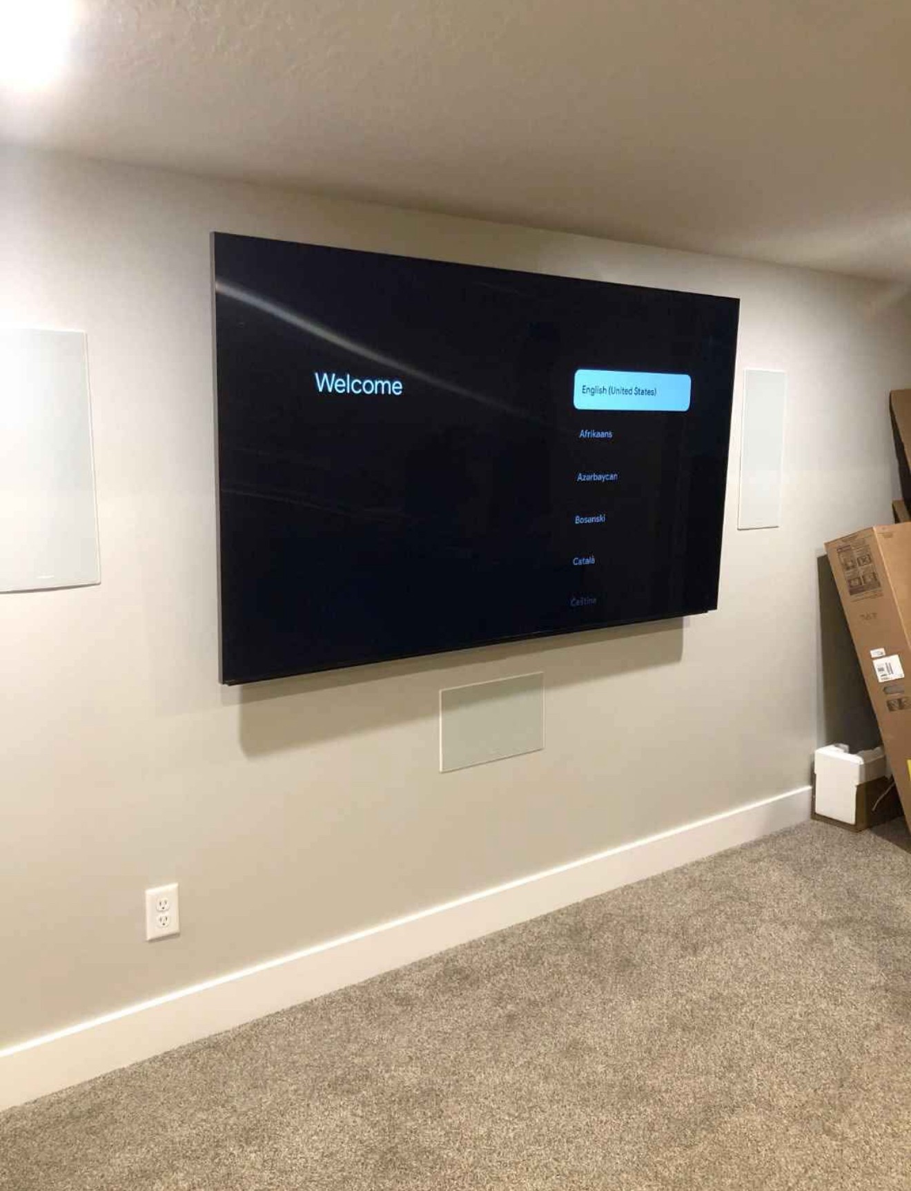 85-inch TV mounted using a swivel arm setup in a residential home in Phoenix, with clean wiring and a modern look.