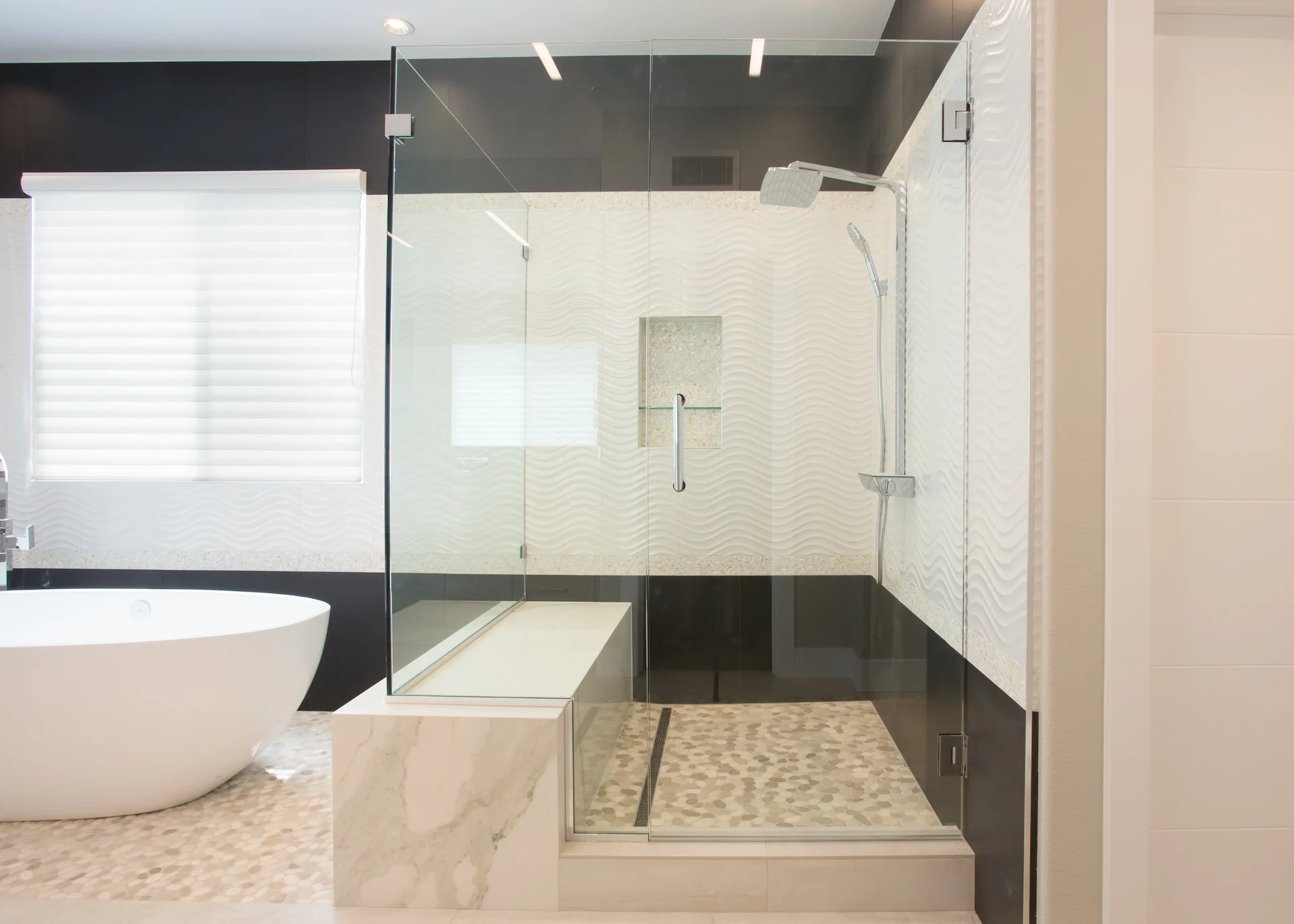 Wide view of the master bath's walk-in shower, a showcase of contemporary elegance and high-quality materials in the Harbor Cove remodel.