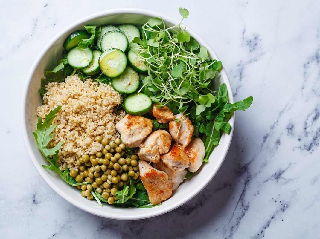 example of a healthy meal with chicken, quinoa, and greens to support the best elliptical workout for weight loss