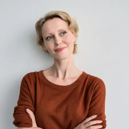 Calm midlife woman in terracotta sweater representing client intake and session prep AI prompt pack for menopause coaches