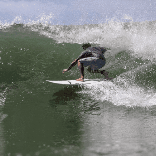 Surfer riding wave on white surfboard – surfboard rental in rio-de-janeiro