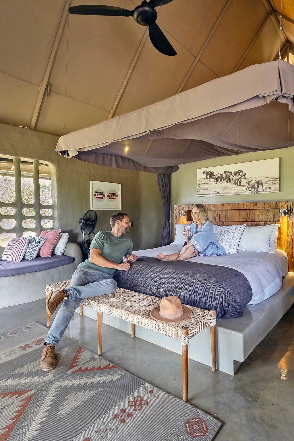 A honeymoon couple chatting in their luxury tented room at Garonga Safari Camp, Makalali Private Game Reserve, South Africa