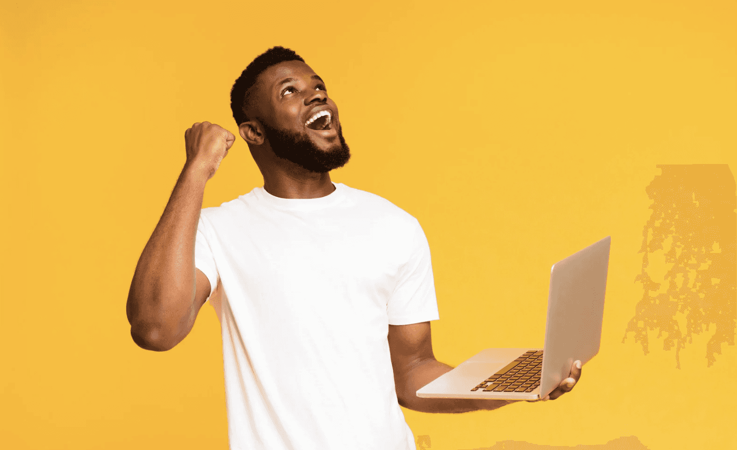 Amazon seller celebrating Q4 results with laptop, showing faster Amazon PPC optimisation during holiday sales spikes.
