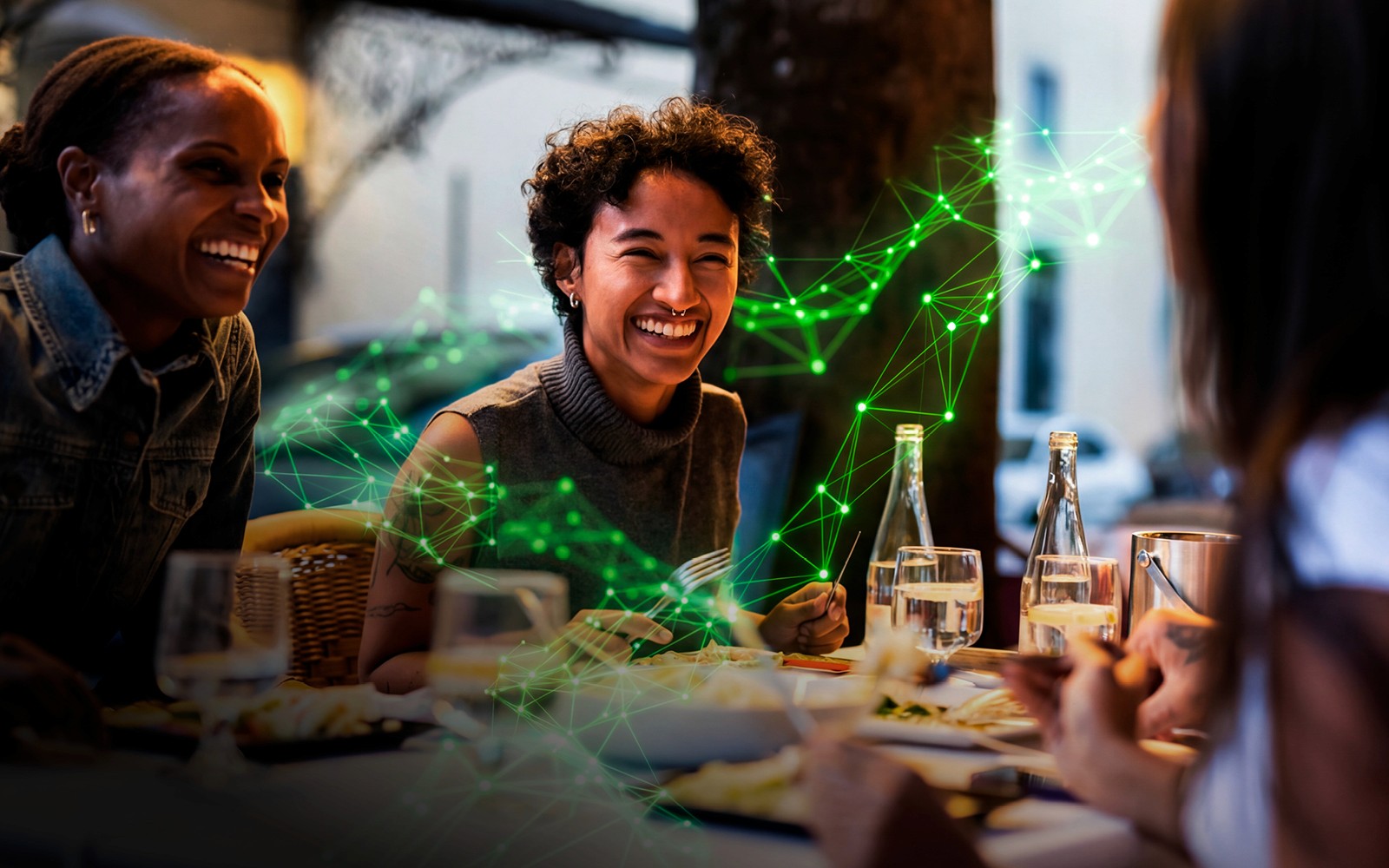 People laughing at a restaurant table with a green digital network overlay