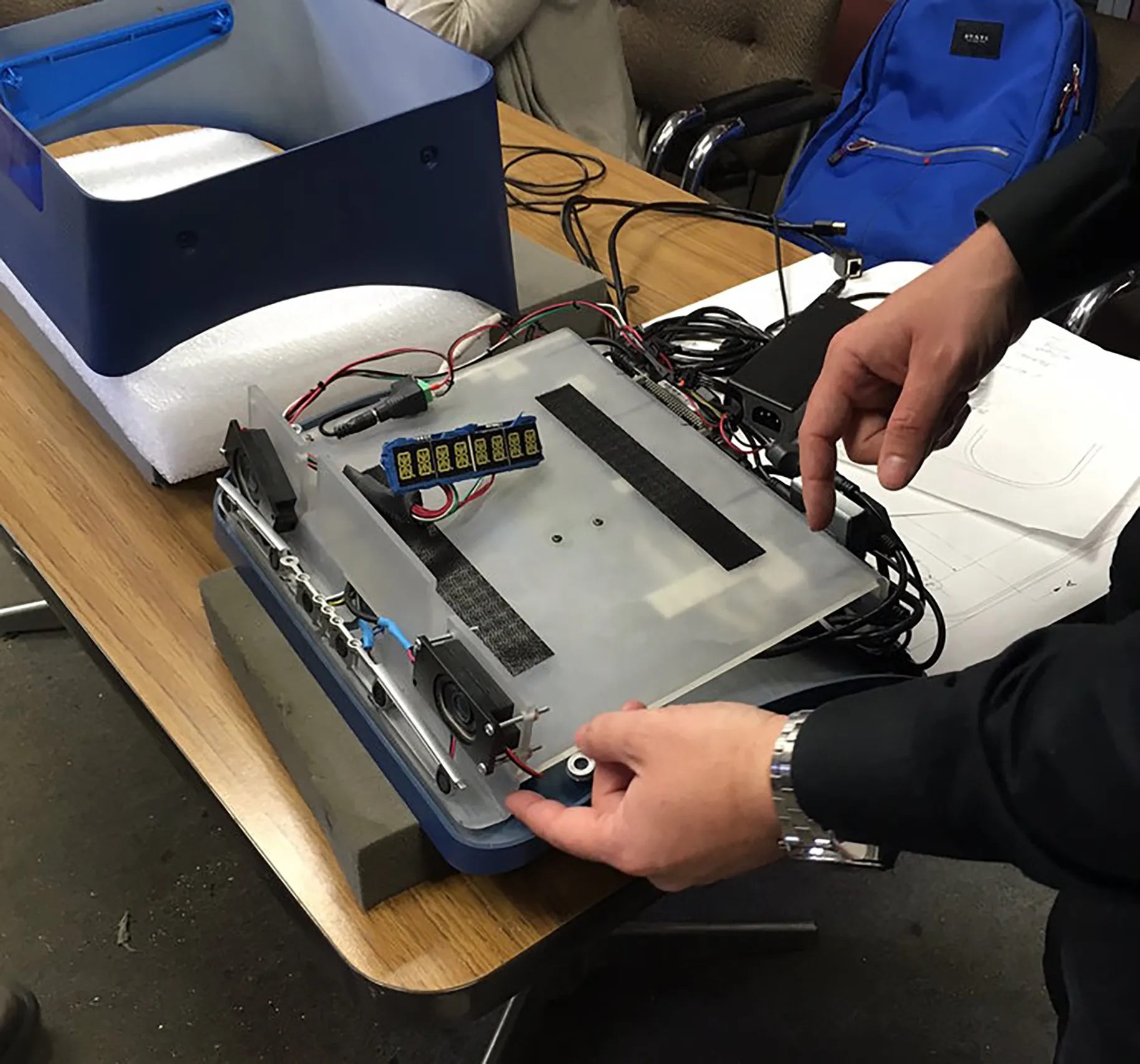 Technician assembling and testing an electronic product prototype