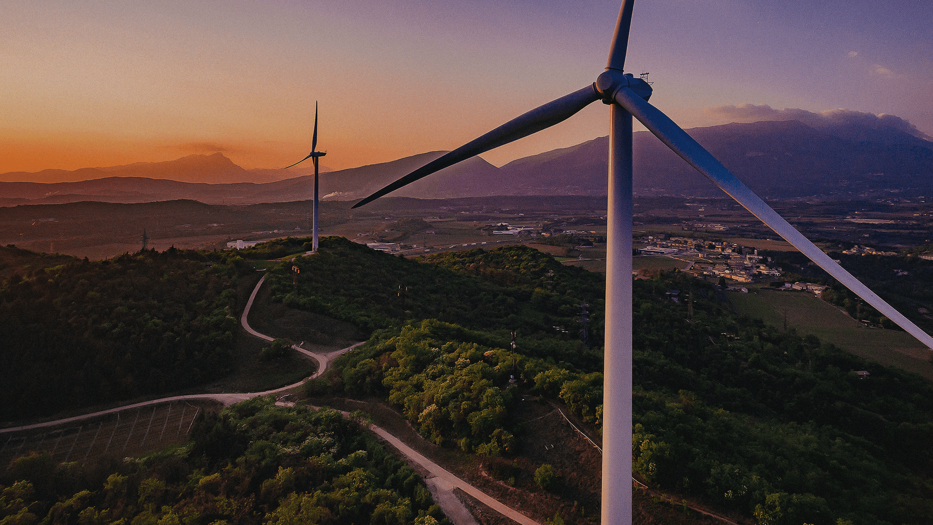 Man with a duffel bag smiling outside a modern office building beside a black van.