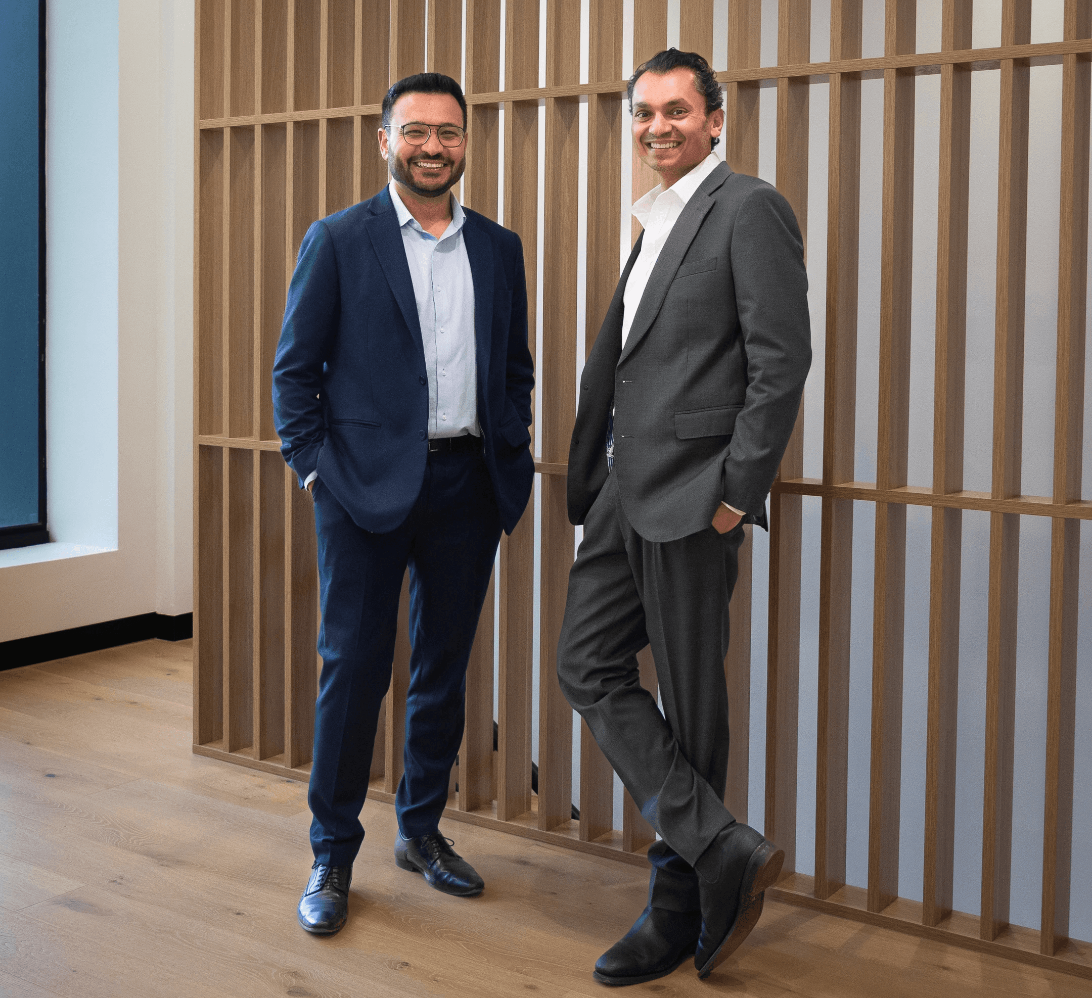 Two businessmen discussing charts on a laptop.