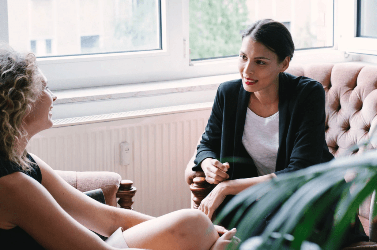 A cozy scene with warm sunlight casting stripes, featuring a potted plant and soft towels on a window sill.