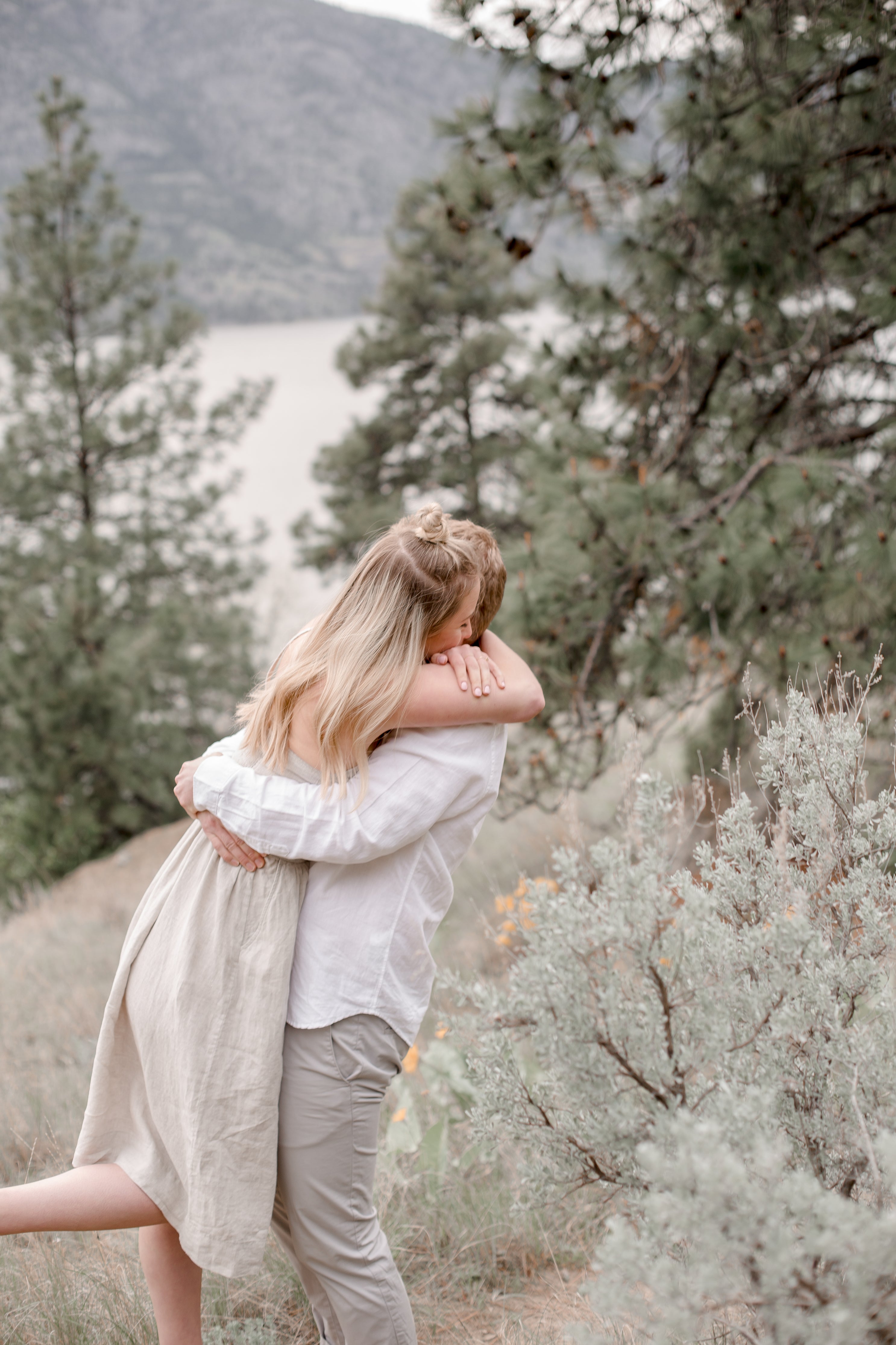 Couple embrace on a mountain
