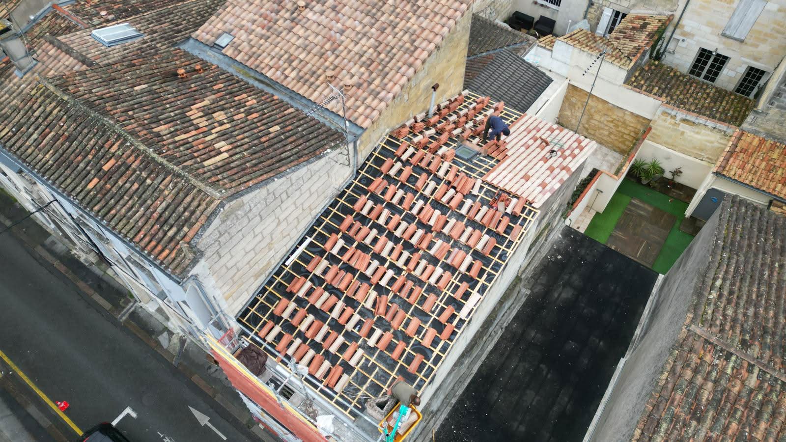 two men working on the roof of a house