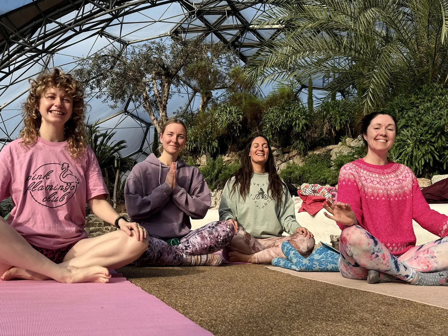 Froomies residents practicing yoga inside the Eden Project biomes in Cornwall