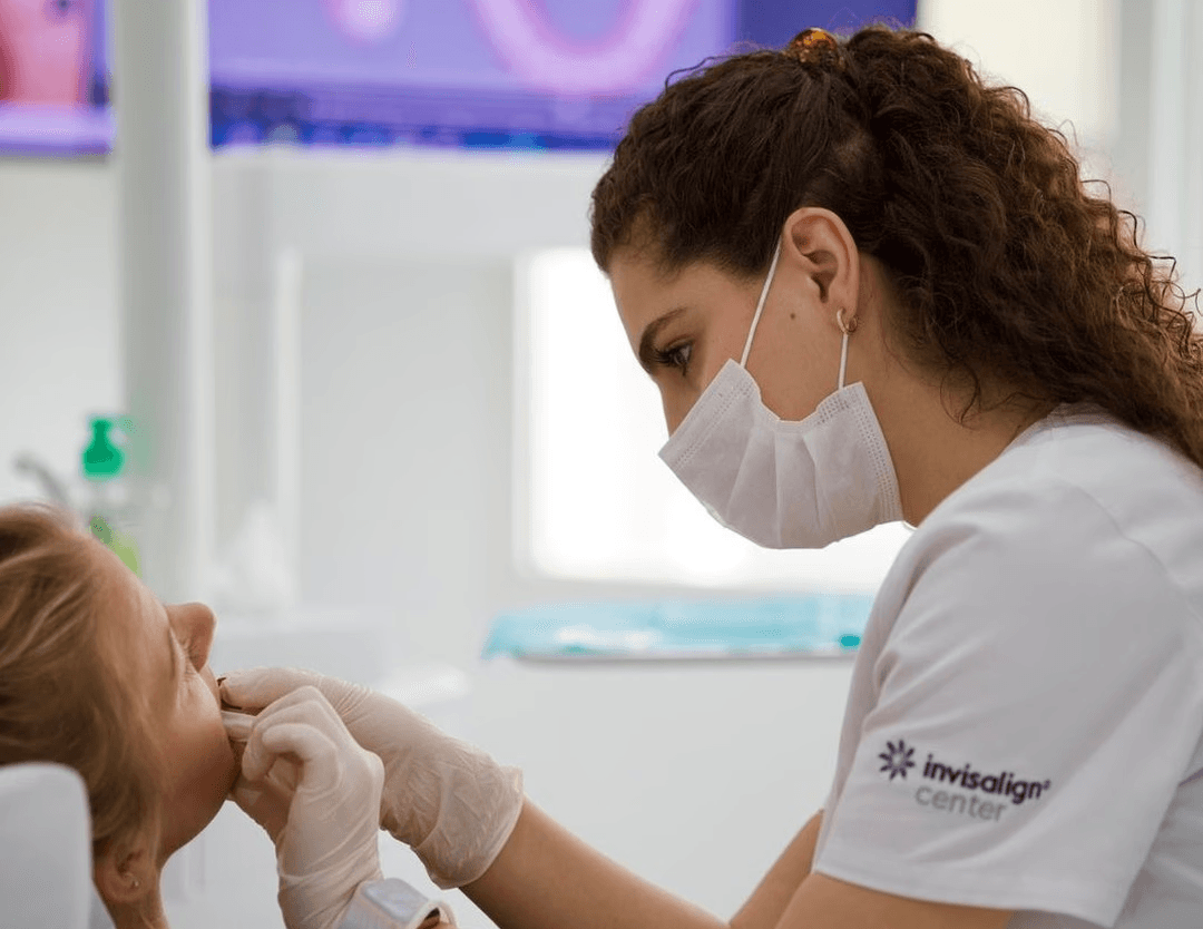 Dentist examining a patient with toothache during an orthodontic treatment check-up