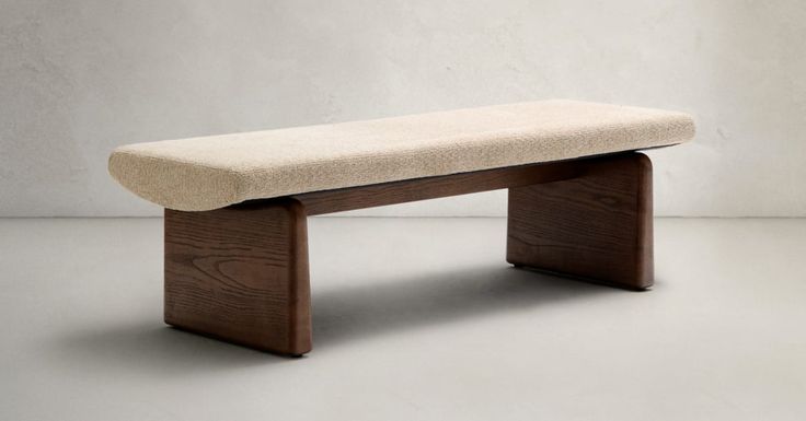 Smiling blonde woman with freckles in a white shirt, arms crossed, minimalist studio portrait.