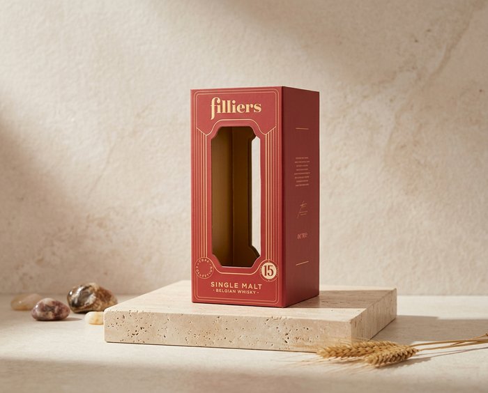 Two boxes of Red Rope rum liqueur on a stone surface.