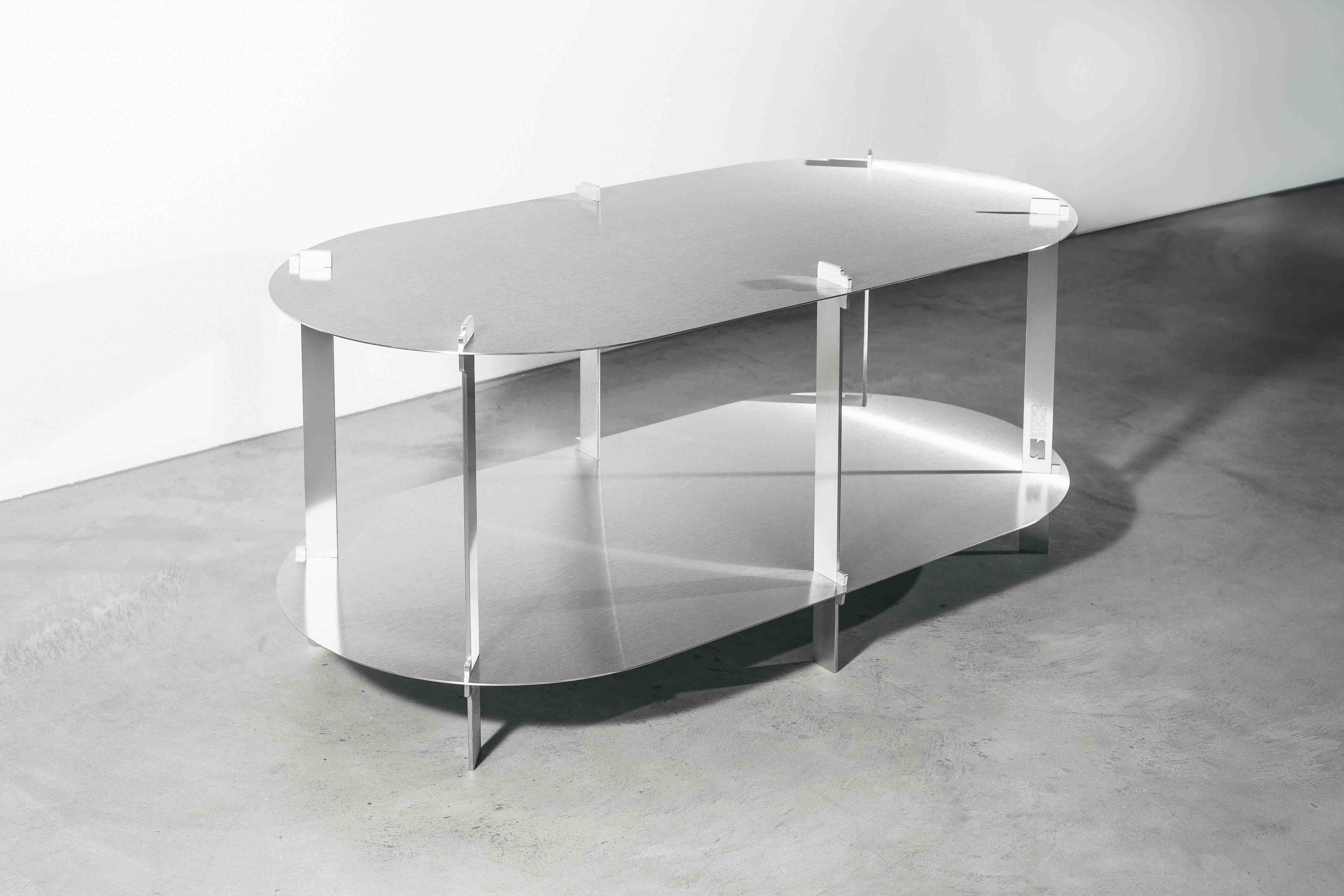 side view of a metal designer table on a concrete floor