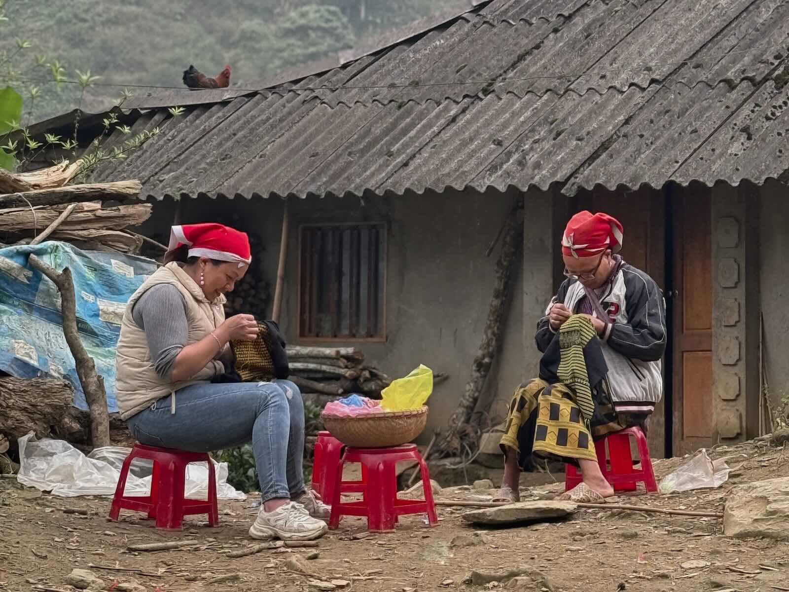 Red Dao women practicing traditional embroidery in Ta Phin village