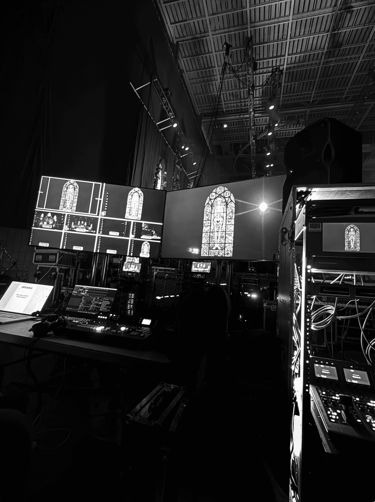 selective photo of camera with tripod and laptop computer turned on