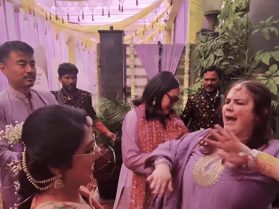A colorful daytime pre-wedding dance circle fills the courtyard