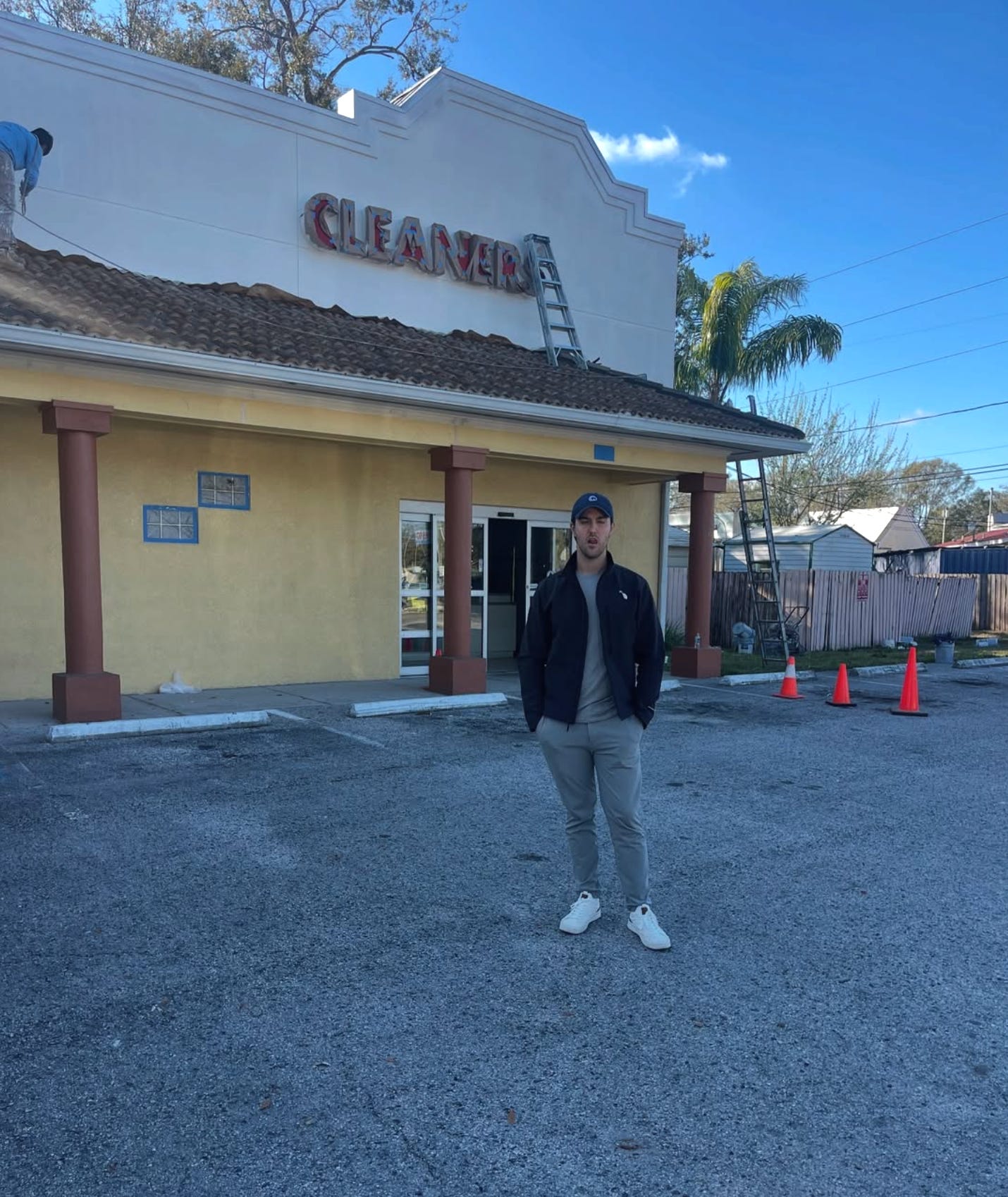 Garrett Greco standing in front of old cleaning building Tampa