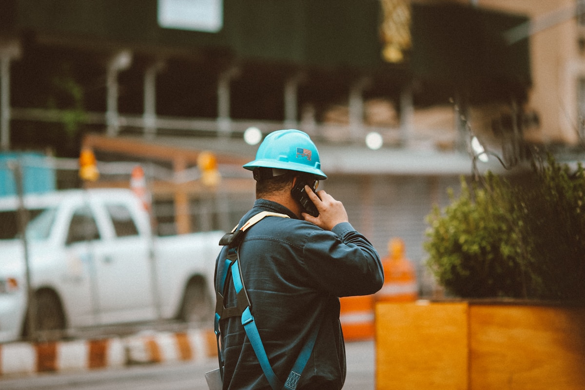 Contractor on a phone near a construction site