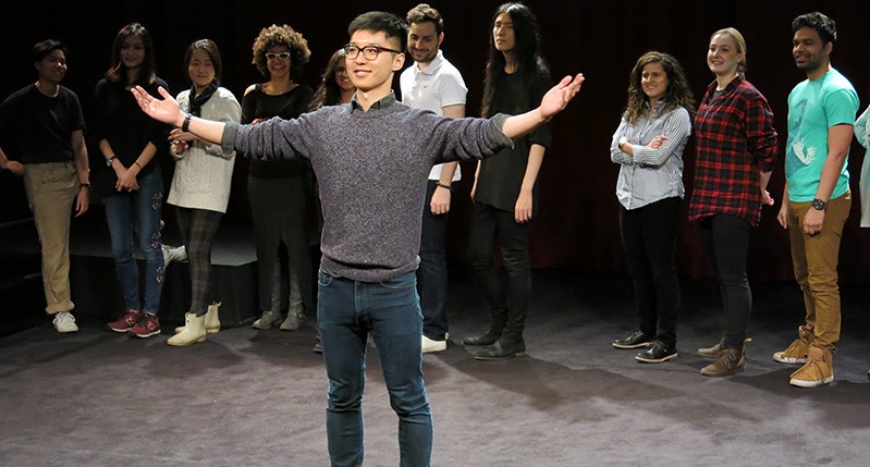 people at theater with man in front