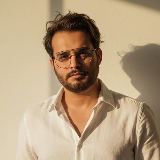 Black and white portrait of a man with a beard and glasses