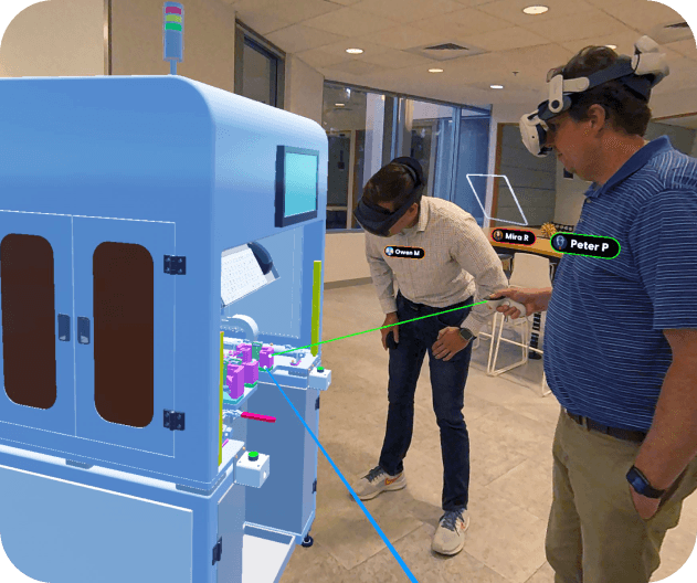 Two people wearing XR headsets review a 3D model of industrial machinery in augmented reality