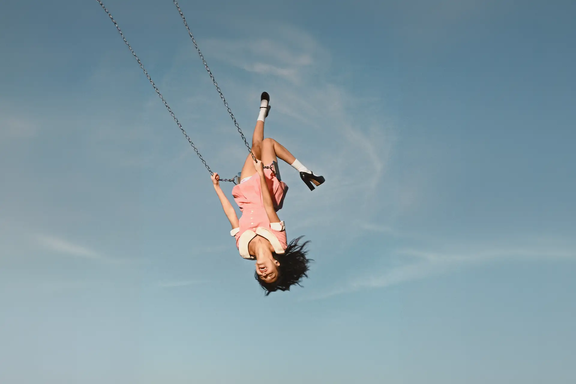 Olivia Rodrigo Swinging on a sing almost upside down