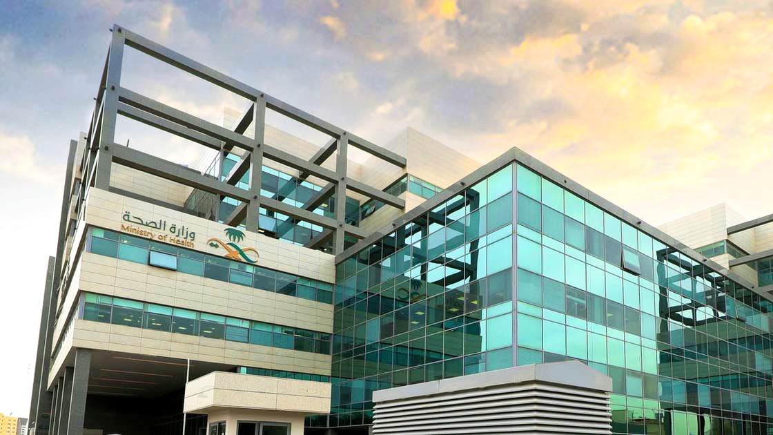 woman holding a phone and man looking at the phone. both are smiling