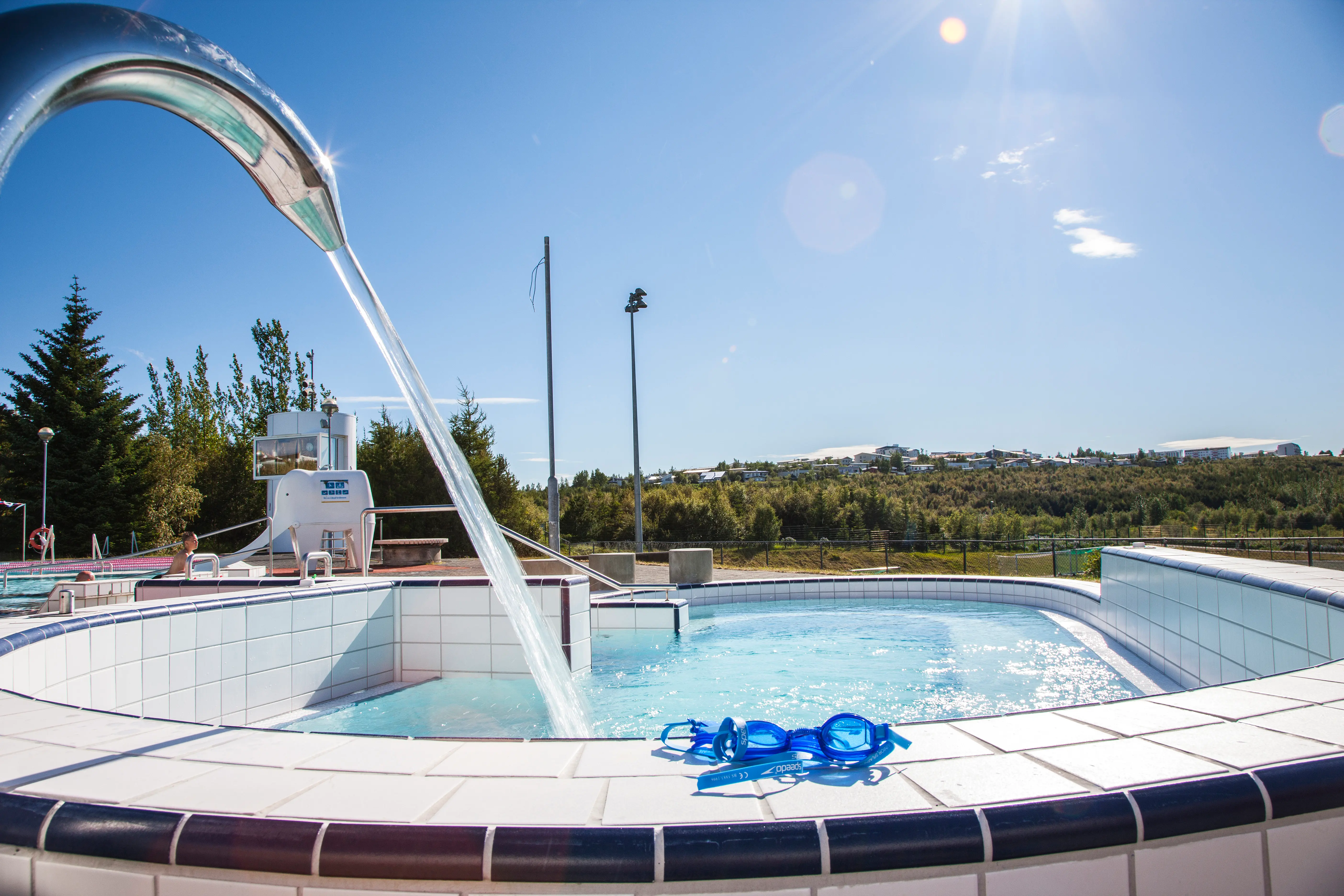 A massage jet in one of the pools at Árbæjarlaug in Reykjavík on a sunny day,