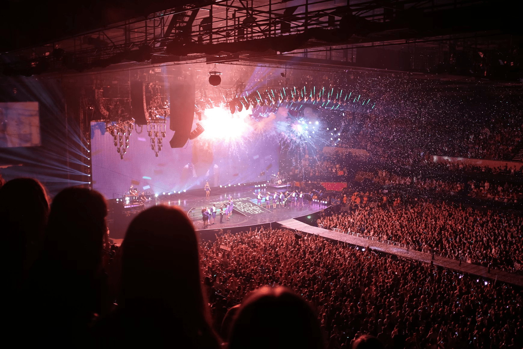 Concert stage with confetti and cheering crowd