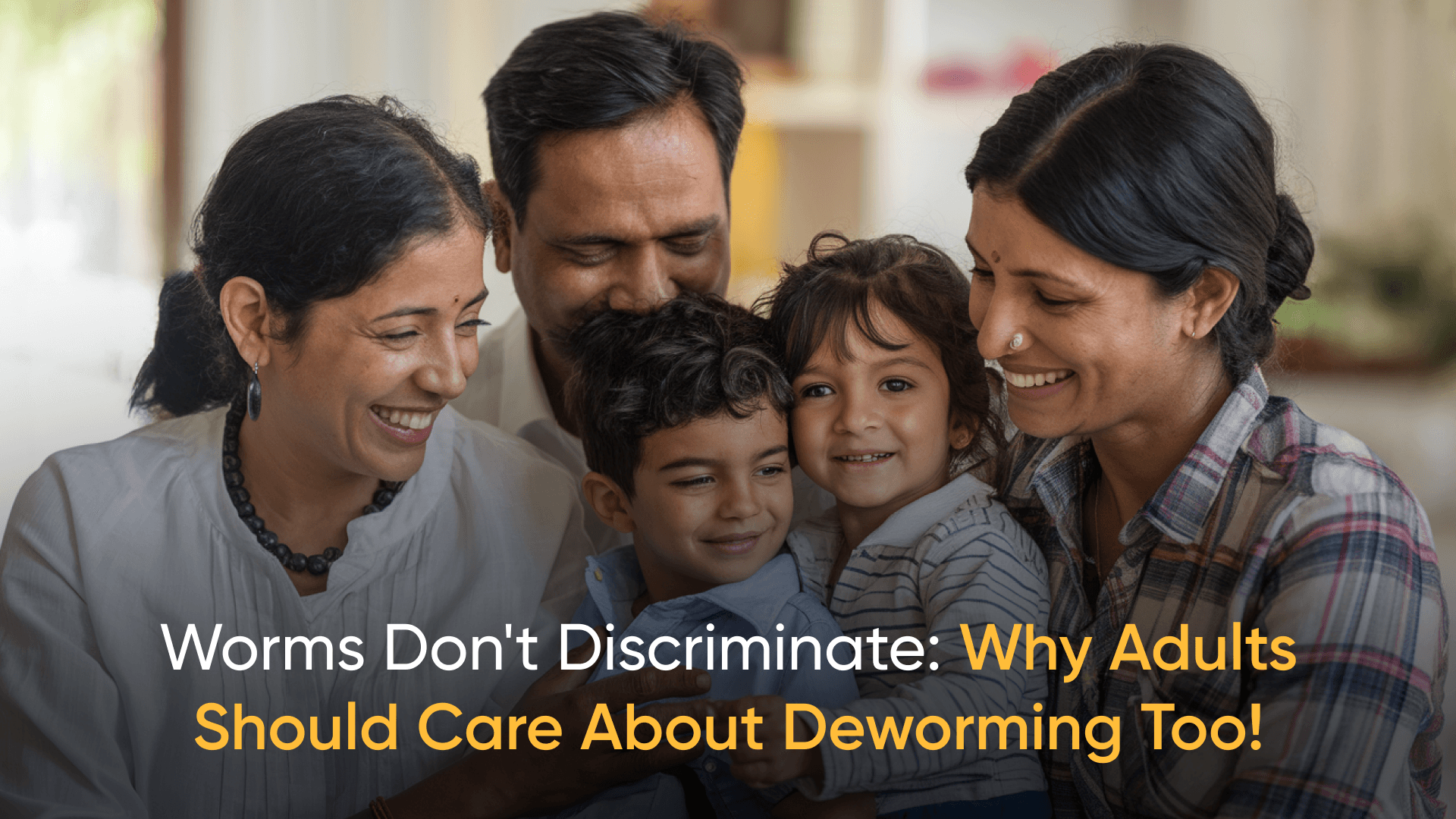 Smiling Indian family with children, emphasizing the importance of deworming for adults.