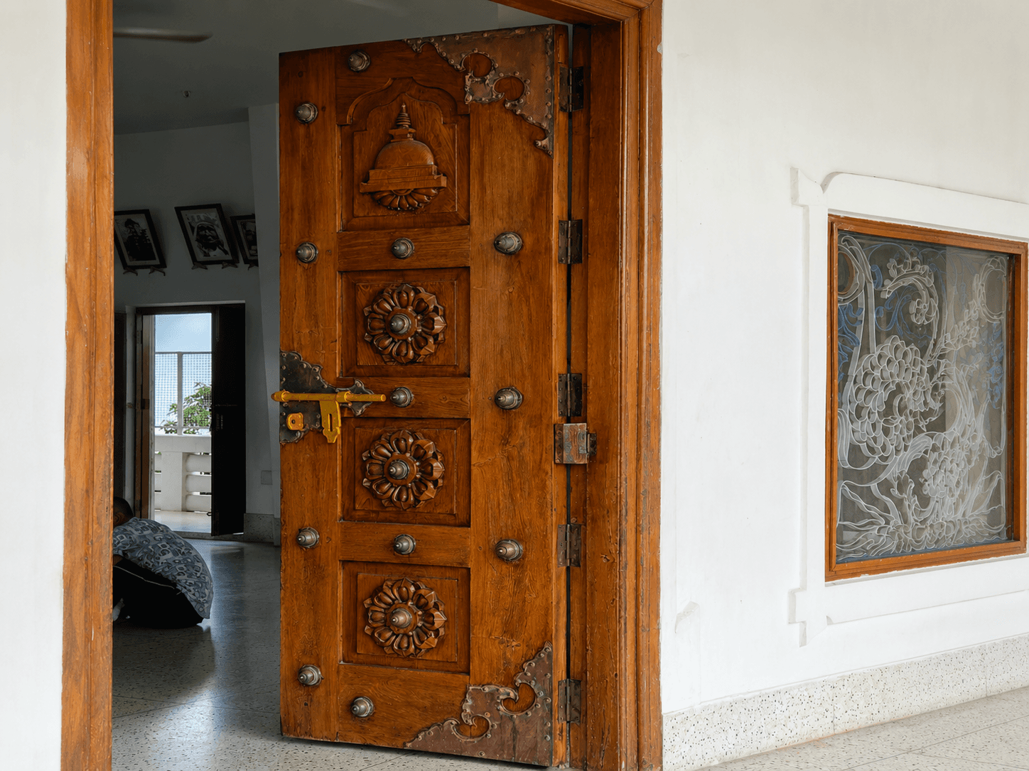 A heavy wood door with visible hinges lock hardware and frame representing the complete door assembly components required for fire rated door compliance