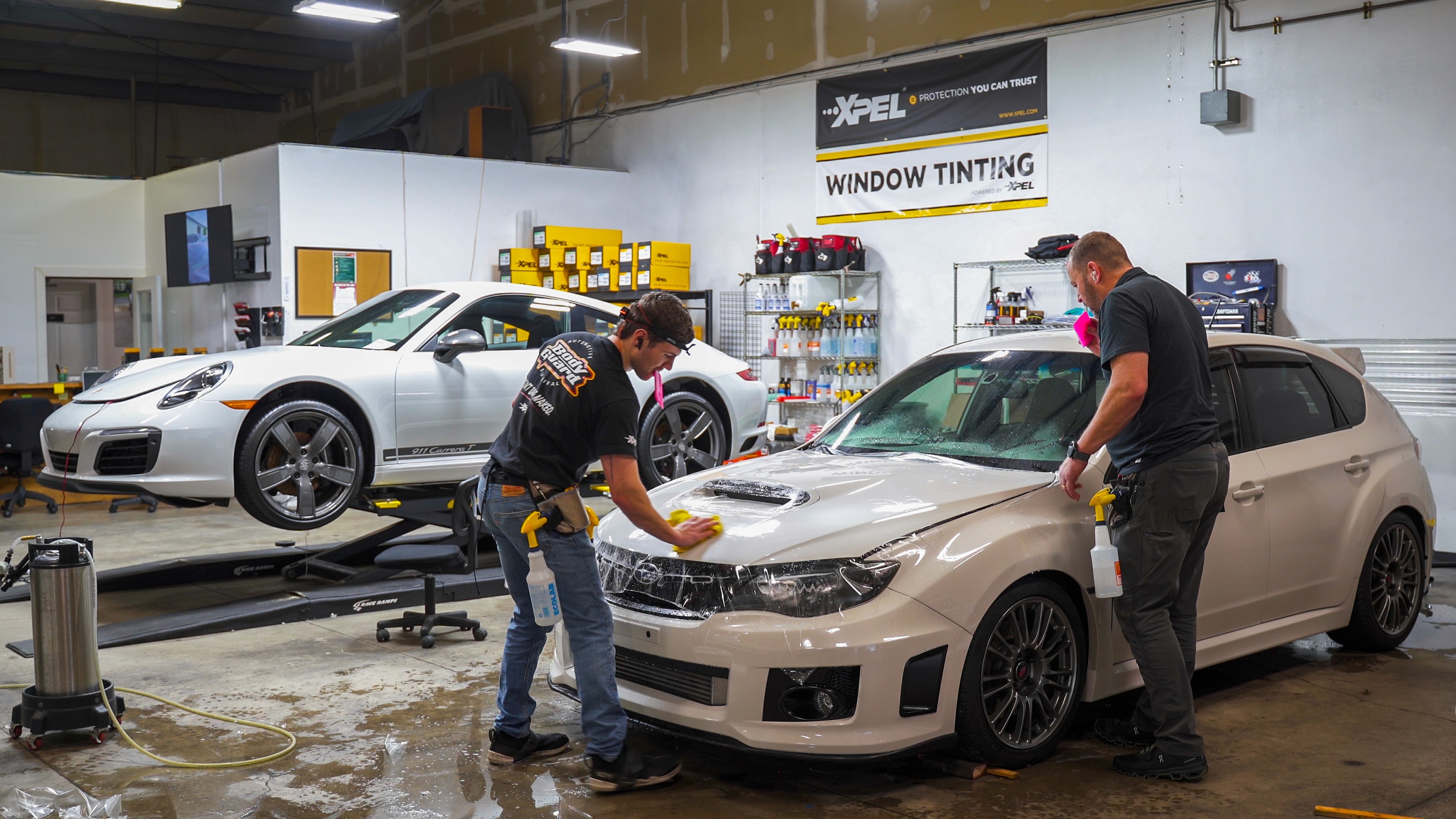 A team of professionals collaborates around a table, discussing documents in a focused and dynamic setting.