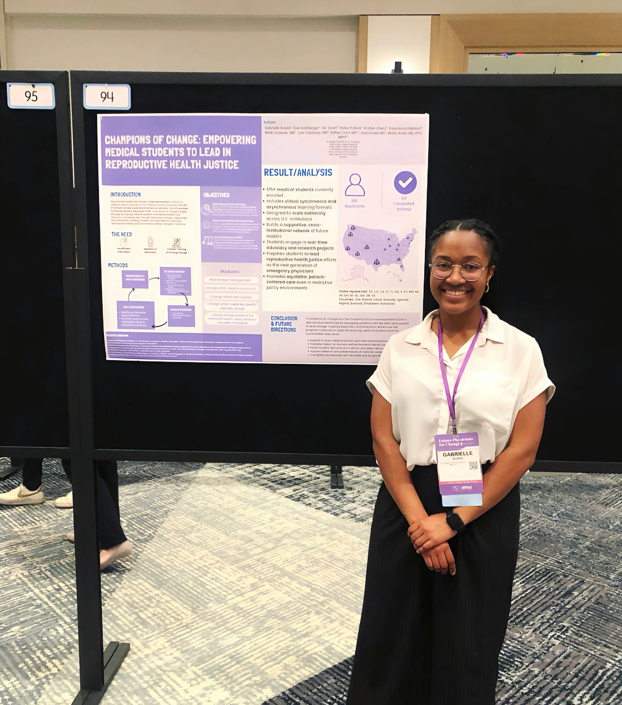 A person stands smiling in front of a conference poster that discusses empowering medical students in reproductive health justice, featuring a purple and white color scheme with graphical elements and a map of the United States.