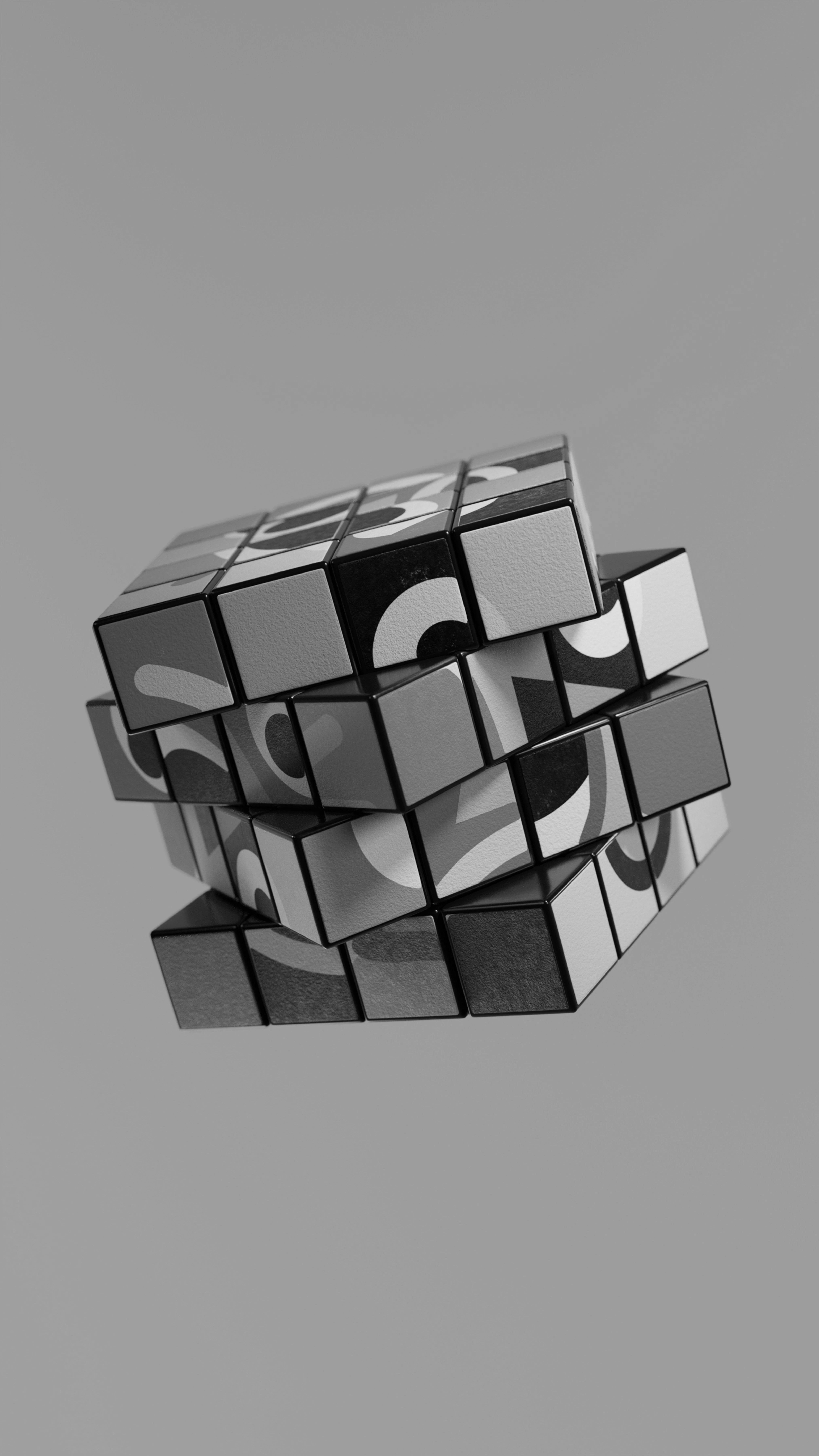 Partially twisted Rubik's cube featuring a black and white, abstract face design.
