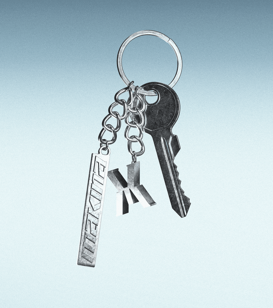 Close-up portrait of a young man with a green beanie and clear-framed glasses lying in the grass, looking directly at the camera.