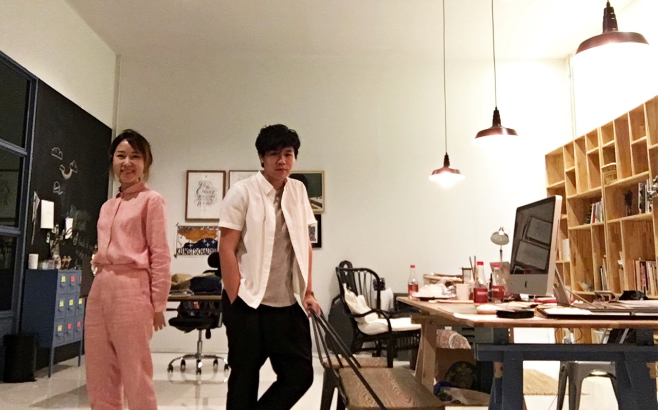 A photo of two people standing in an art workshop.