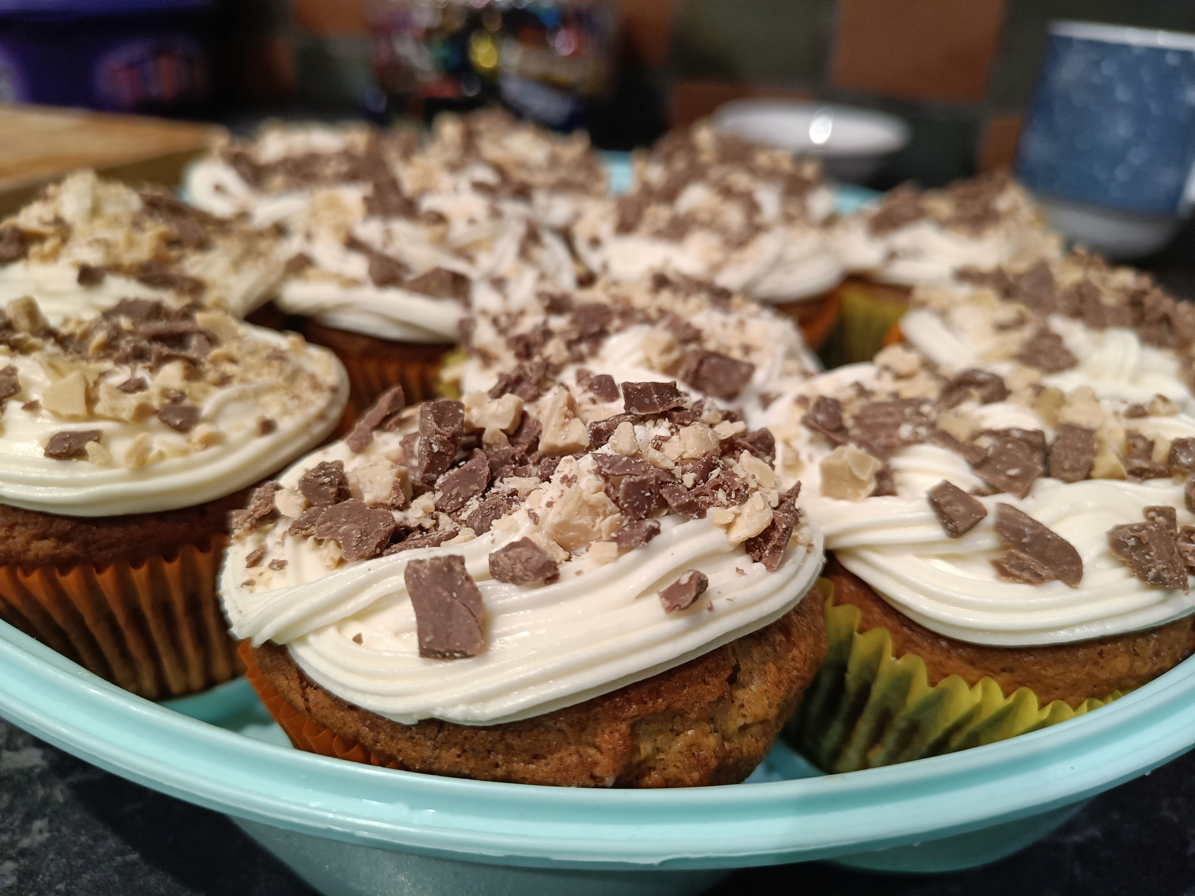 Plate of chocolate-topped cupcakes on a turquoise tray.