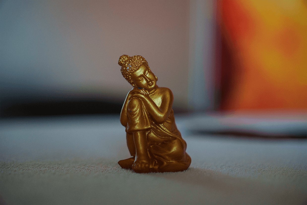 A woman receives a relaxing energy healing in a serene setting with soft lighting.