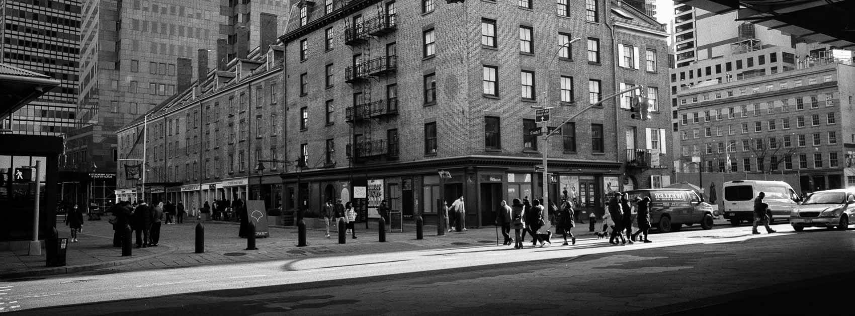 NYC pictures black and white where shadows meet people roaming the city, panoramic Hasselblad XPan workflow moment.