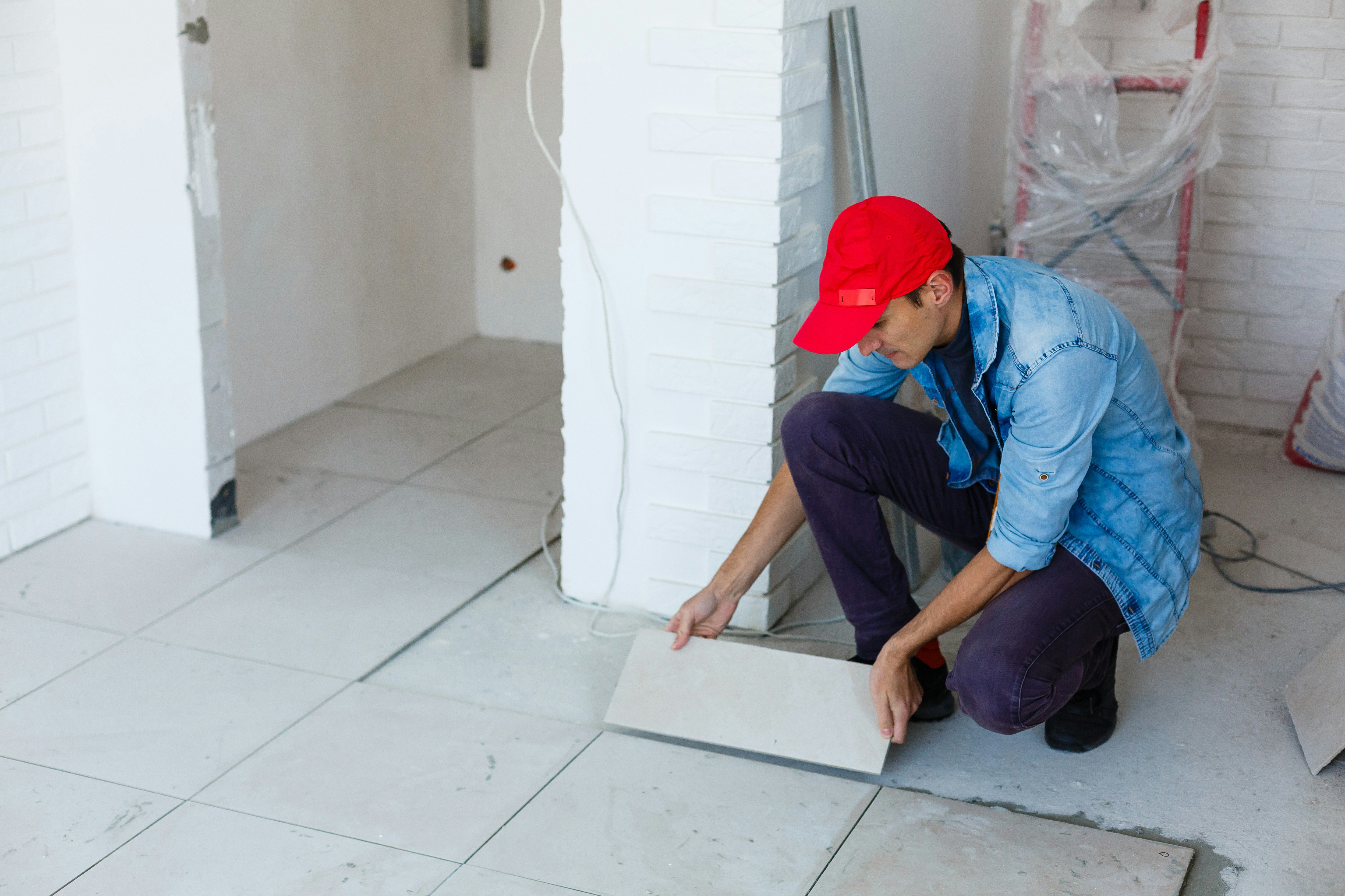 woman in gray shirt sitting on brown wooden floor