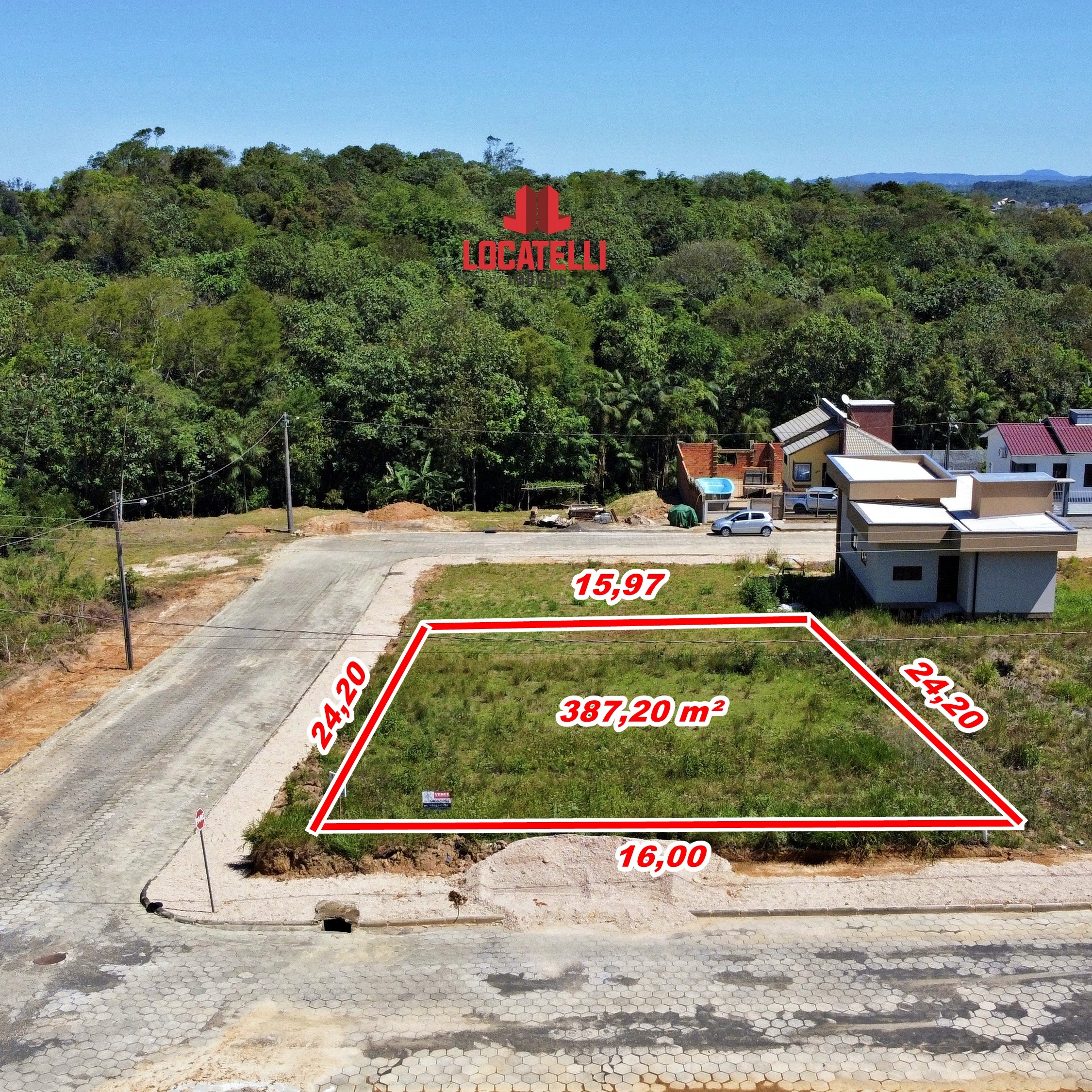 A modern brick house with a two-car garage, well-manicured lawn, and clear blue sky in the background.