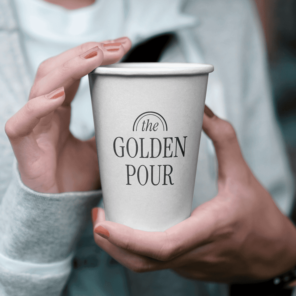 Close-up cup mockup emphasizing the logo application and clean, modern café identity.