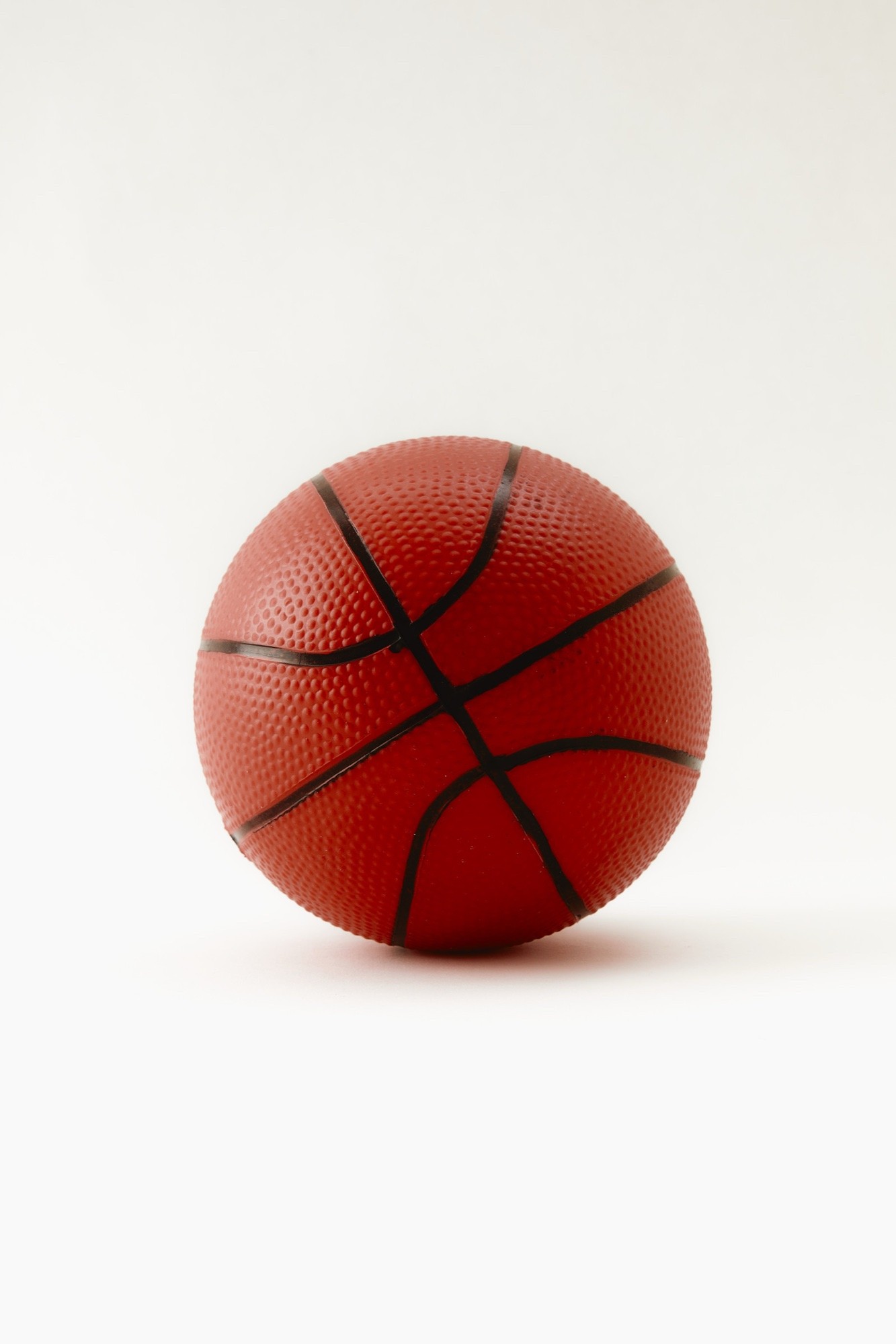 Basketball centred on an off white backdrop