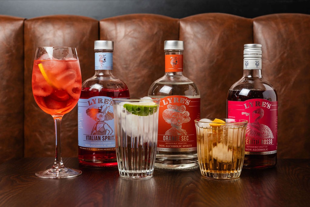 two glass of iced tea with some orange fruit around them