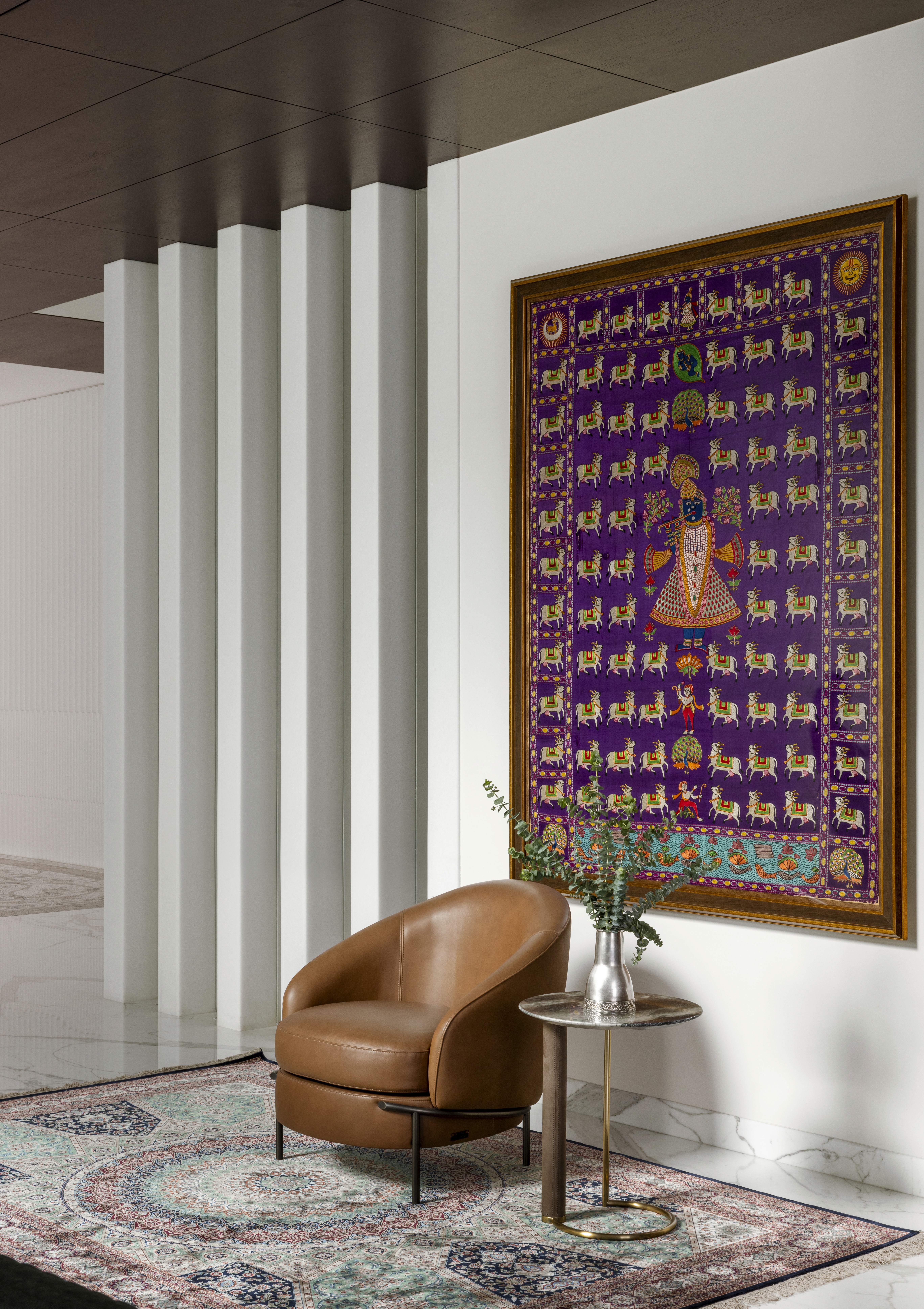 Sunlit modern living room with gray sofa, artwork.
