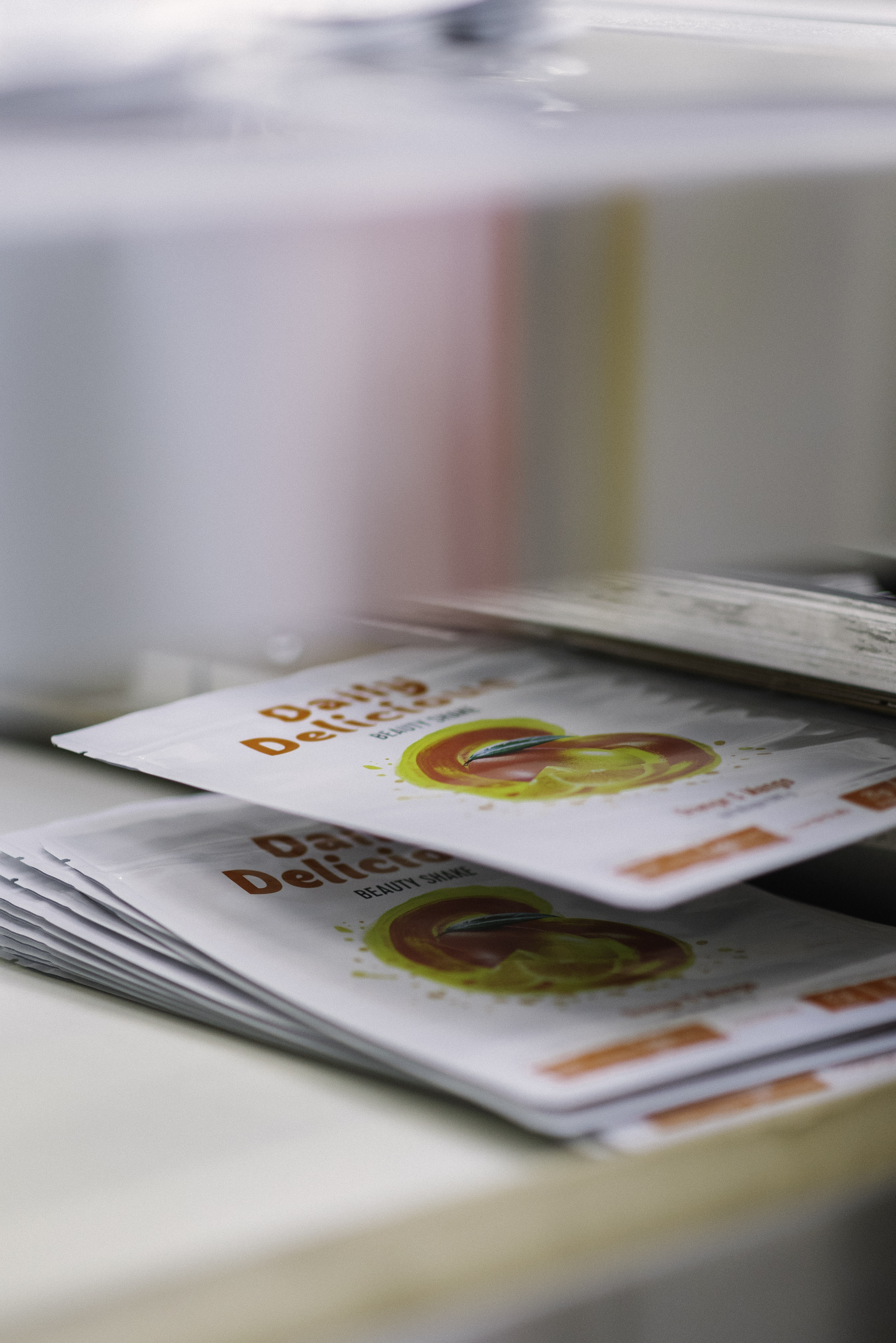 Sets of printed packaging lined up on the production line, ready for the next step.kaging materials moving through a production line at Scheyer, ready for quality inspection.