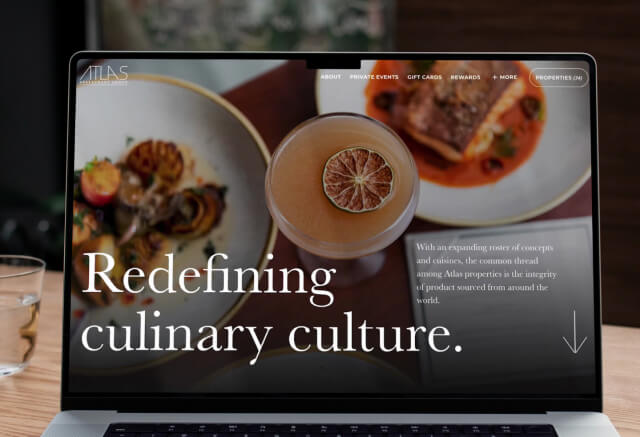 A laptop screen displays a restaurant website with images of gourmet dishes and a cocktail, featuring the text Redefining culinary culture.